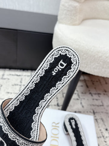 DIOR 26S HIGH HEEL SLIDES IN BLACK AND WHITE EMBOSSED OBLIQUE LACE EMBROIDERY