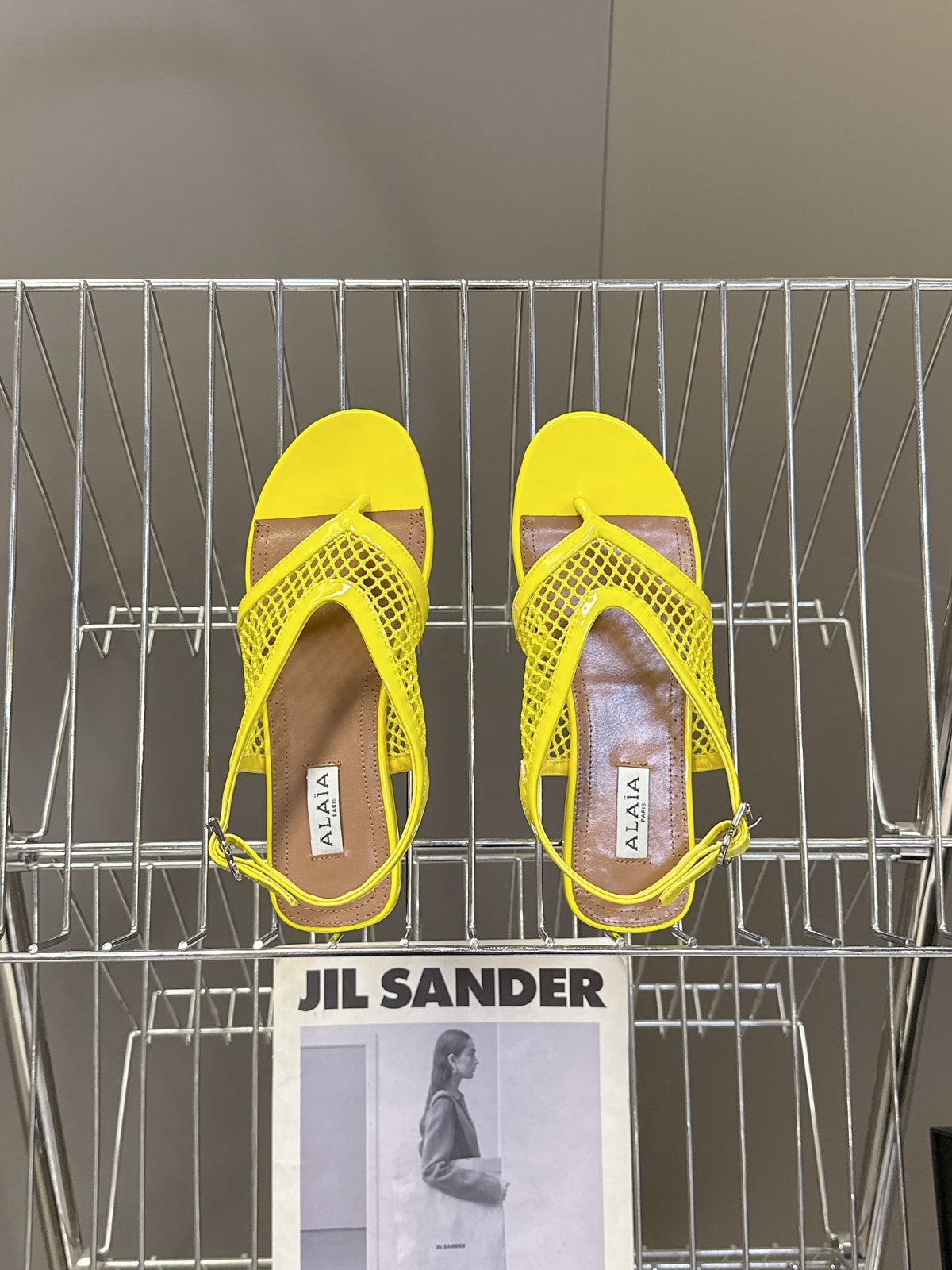 ALAIA 26S FLAT MESH THONG SANDALS IN YELLOW PATENT CALFSKIN