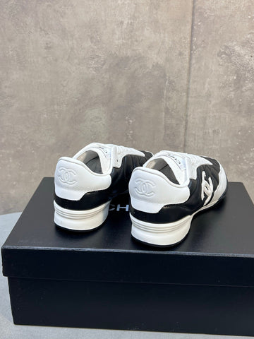 CHANEL 26S SNEAKERS IN BLACK AND WHITE QUILTED CALFSKIN CC LOGO