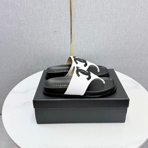CHANEL 26S CC THONG SLIDES IN WHITE AND BLACK LAMBSKIN