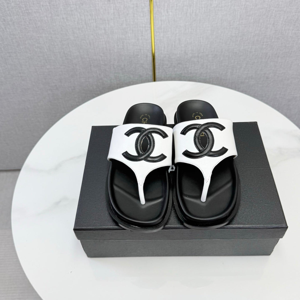 CHANEL 26S CC THONG SLIDES IN WHITE AND BLACK LAMBSKIN